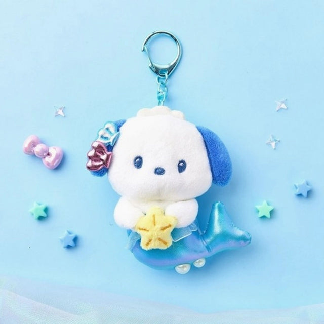 An officially licensed Sanrio character, Pochacco is reimagined with a shimmering metallic blue mermaid tail. The character is holding a small yellow starfish and has blue and pink shell accessories on its head, complete with a blue plastic clip.