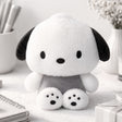 An officially licensed Sanrio Pochacco plush doll dressed in grey overalls with detailed black paw prints on his feet