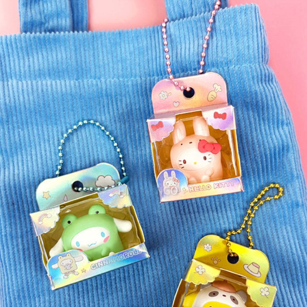 Five officially licensed Sanrio mini figures in colorful animal costumes, each packaged in a colorful box with a ball chain at the top. The collection includes Cinnamoroll, My Melody, Pochacco, Pompompurin, and Hello Kitty.