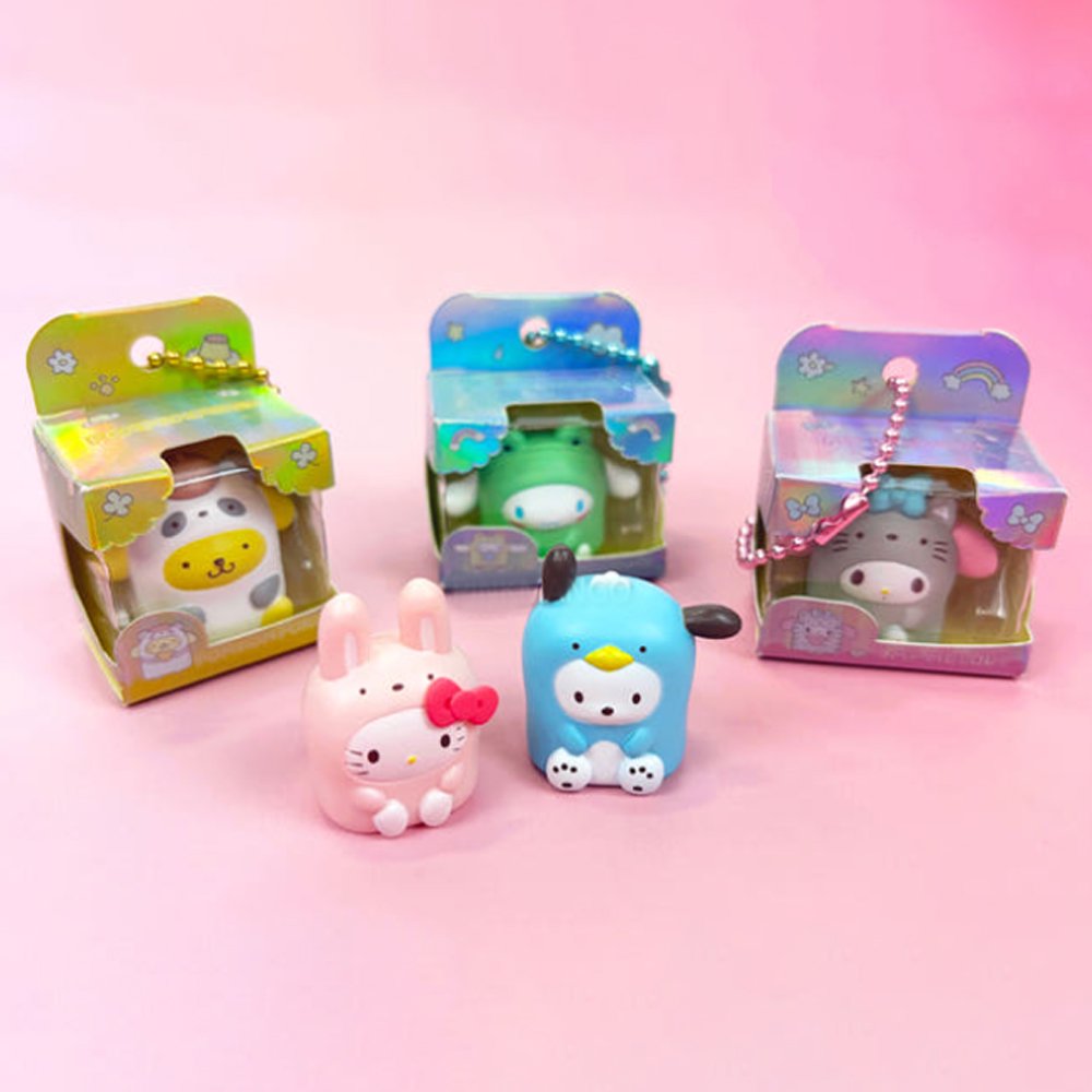 Five officially licensed Sanrio mini figures in colorful animal costumes, each packaged in a colorful box with a ball chain at the top. The collection includes Cinnamoroll, My Melody, Pochacco, Pompompurin, and Hello Kitty.