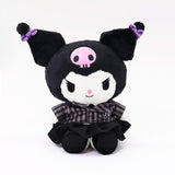 Officially licensed Sanrio Kuromi plush doll, wearing a black and white plaid school uniform dress with a black velvet pleated skirt. Kuromi's signature pink skull is embroidered on her black head. 