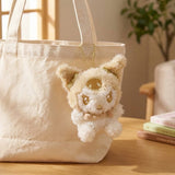 An officially licensed small and fluffy Sanrio characters Hello Kitty, My Melody, Cinnamoroll, Kuromi, Pompompurin, Pochacco, and Hangyodon sparkling gold tinsel fur and a metallic gold accessories.