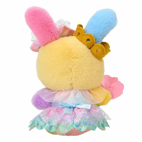 A plush keychain of the Sanrio bunny character Usahana. She has yellow fur with one blue ear and one pink ear. She wears a golden crown, a pastel rainbow gradient bow, and a pink princess dress with a floral organza overlay. She holds a pink flower and is attached to a silver metal lobster clasp.
