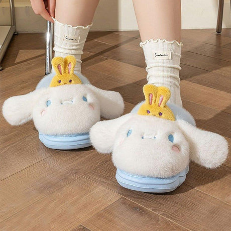 Sanrio officially licensed Cinnamoroll Bunny Head Fur Slippers for children. Features include a fluffy white exterior, iconic Cinnamoroll face with yellow bunny face, and a soft, warm lining perfect for home lounging.