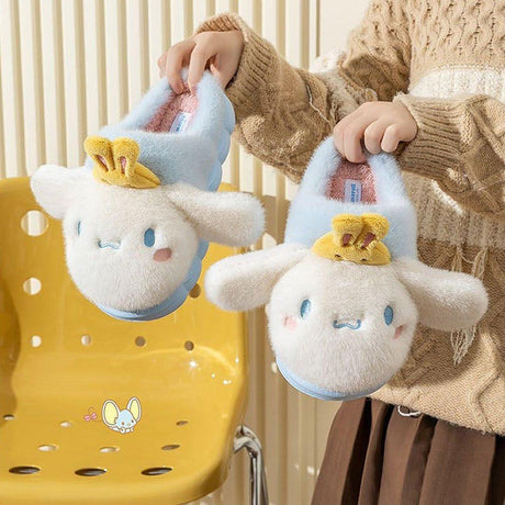 Sanrio officially licensed Cinnamoroll Bunny Head Fur Slippers for children. Features include a fluffy white exterior, iconic Cinnamoroll face with yellow bunny face, and a soft, warm lining perfect for home lounging.