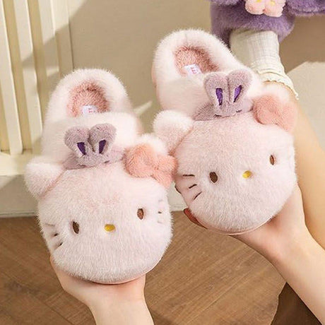 Sanrio officially licensed Hello Kitty Bunny Head Fur Slippers for children. Features include a fluffy pink exterior, iconic Hello Kitty face with bunny ears, and a soft, warm lining perfect for home lounging.