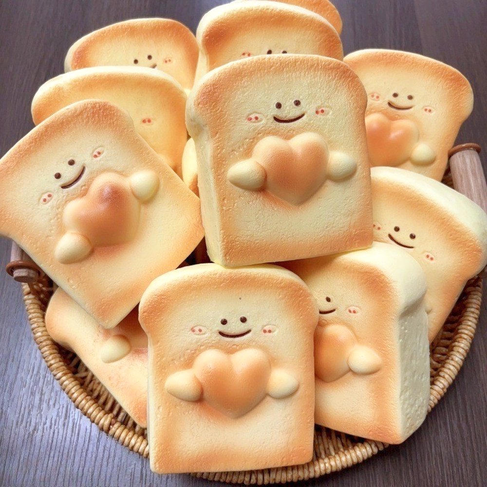 Realistic slice-of-bread squishy stress toy with a sweet smiling face and golden crust