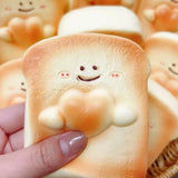 Realistic slice-of-bread squishy stress toy with a sweet smiling face and golden crust