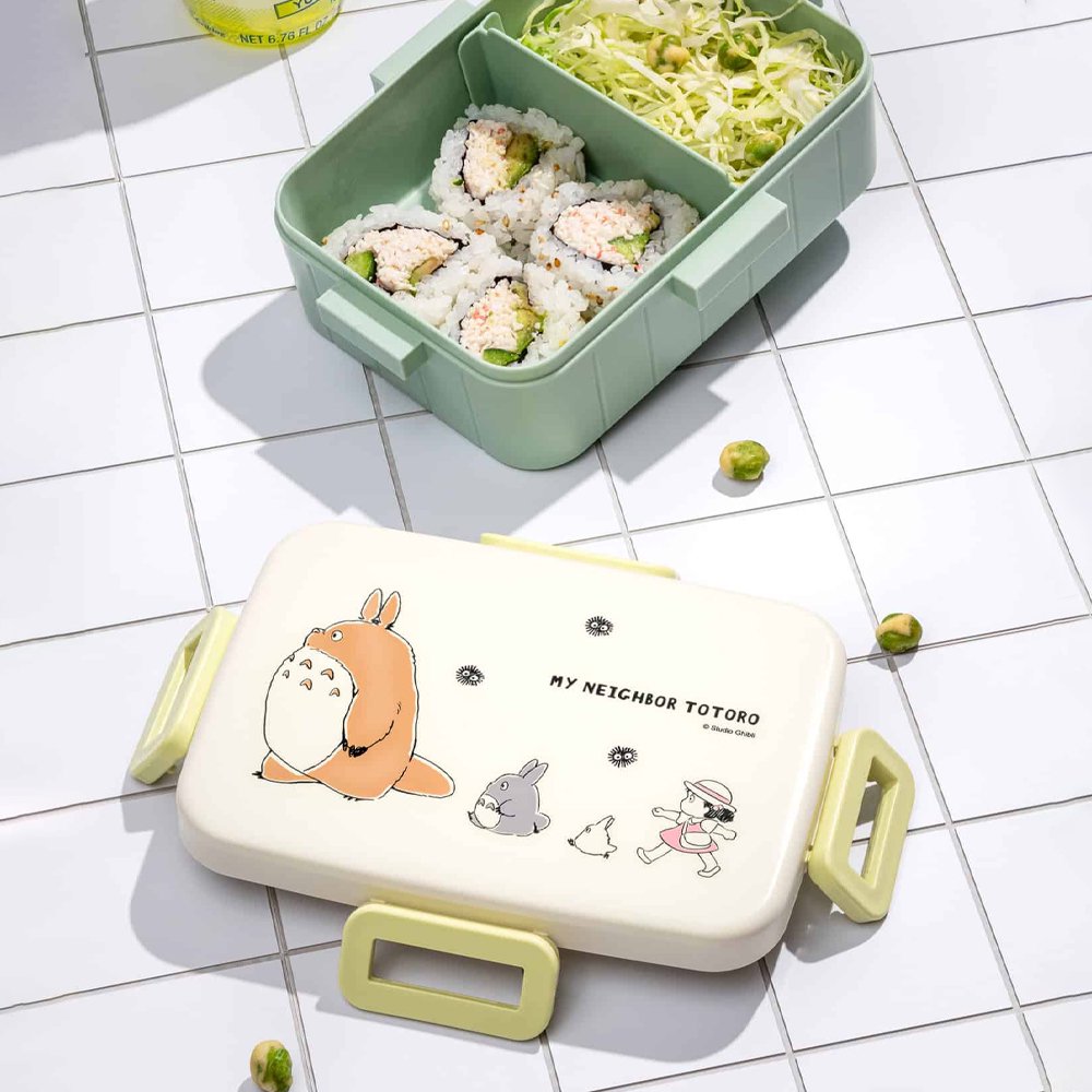Officially licensed Ghibli My Neighbor Totoro Skater bento lunch box in sage green with an open cream lid displaying Mei and Totoro illustrations with a removable divider