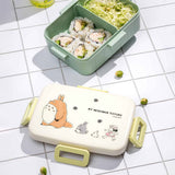 Officially licensed Ghibli My Neighbor Totoro Skater bento lunch box in sage green with an open cream lid displaying Mei and Totoro illustrations with a removable divider