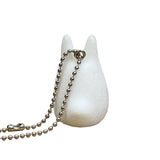 Officially licensed Studio Ghibli small White Totoro (Chibi-Totoro) flocked mascot keychain, featuring a fuzzy white texture and black eyes.