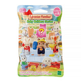 A collection of eight officially licensed Sylvanian Families baby figures in DIY themes, including a cat with a hammer, a giraffe with a paint roller, and a rabbit in a paint bucket. A pink question mark silhouette represents the eighth mystery figure in the series.