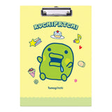 Two officially licensed Tamagotchi clipboards: one light blue featuring Mametchi with cupcakes and sweets, and one pale yellow featuring Kuchipatchi with stars and snacks. Both clipboards include a silver metal clip and the official Tamagotchi logo.