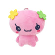 Officially licensed Tamagotchi plush keychain of the character Floritchi, featuring a pink body with yellow and green felt flower accessories on its head and a ball-chain attachment for bags or keys.