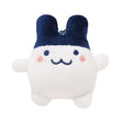 Officially licensed Tamagotchi plush keychain of the character Mimitchi, featuring a round white body, large navy blue ears, and a simple embroidered face with pink rosy cheeks and a "w" shaped mouth and a ball-chain attachment for bags or keys.