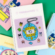A set of four officially licensed Tamagotchi spiral notebooks in yellow, purple, blue, and pink, each featuring different character illustrations.
