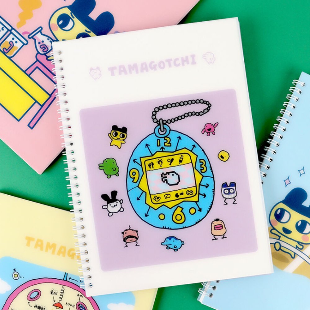 A set of four officially licensed Tamagotchi spiral notebooks in yellow, purple, blue, and pink, each featuring different character illustrations.