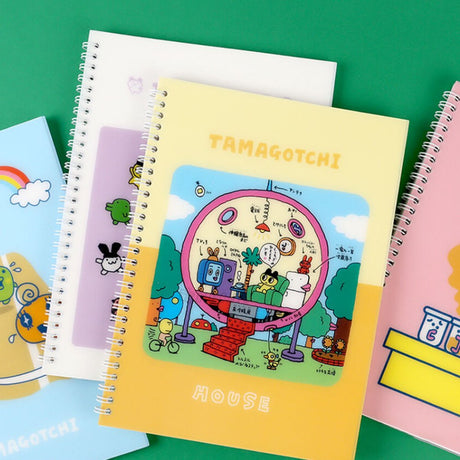 A set of four officially licensed Tamagotchi spiral notebooks in yellow, purple, blue, and pink, each featuring different character illustrations.