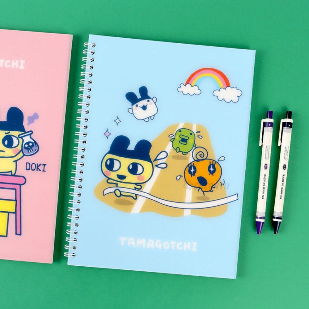 A set of four officially licensed Tamagotchi spiral notebooks in yellow, purple, blue, and pink, each featuring different character illustrations.