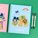 A set of four officially licensed Tamagotchi spiral notebooks in yellow, purple, blue, and pink, each featuring different character illustrations.