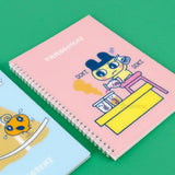 A set of four officially licensed Tamagotchi spiral notebooks in yellow, purple, blue, and pink, each featuring different character illustrations.