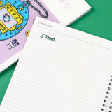 A set of four officially licensed Tamagotchi spiral notebooks in yellow, purple, blue, and pink, each featuring different character illustrations.