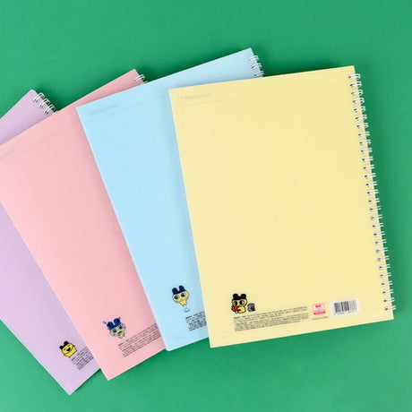 A set of four officially licensed Tamagotchi spiral notebooks in yellow, purple, blue, and pink, each featuring different character illustrations.