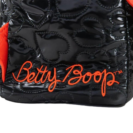 Black quilted heart-pattern backpack featuring Betty Boop and Pudgy character patches, vibrant red trim, and decorative gold chain charms shaped like red lips and Pudgy the dog.