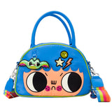 An officially licensed Whatever! blue dome-shaped handbag featuring a large character face with giant black eyes and pink cheeks. The bag is decorated with a green bat-winged patch, a star, and a lightning bolt. It includes blue top handles and a detachable rainbow-striped shoulder strap.