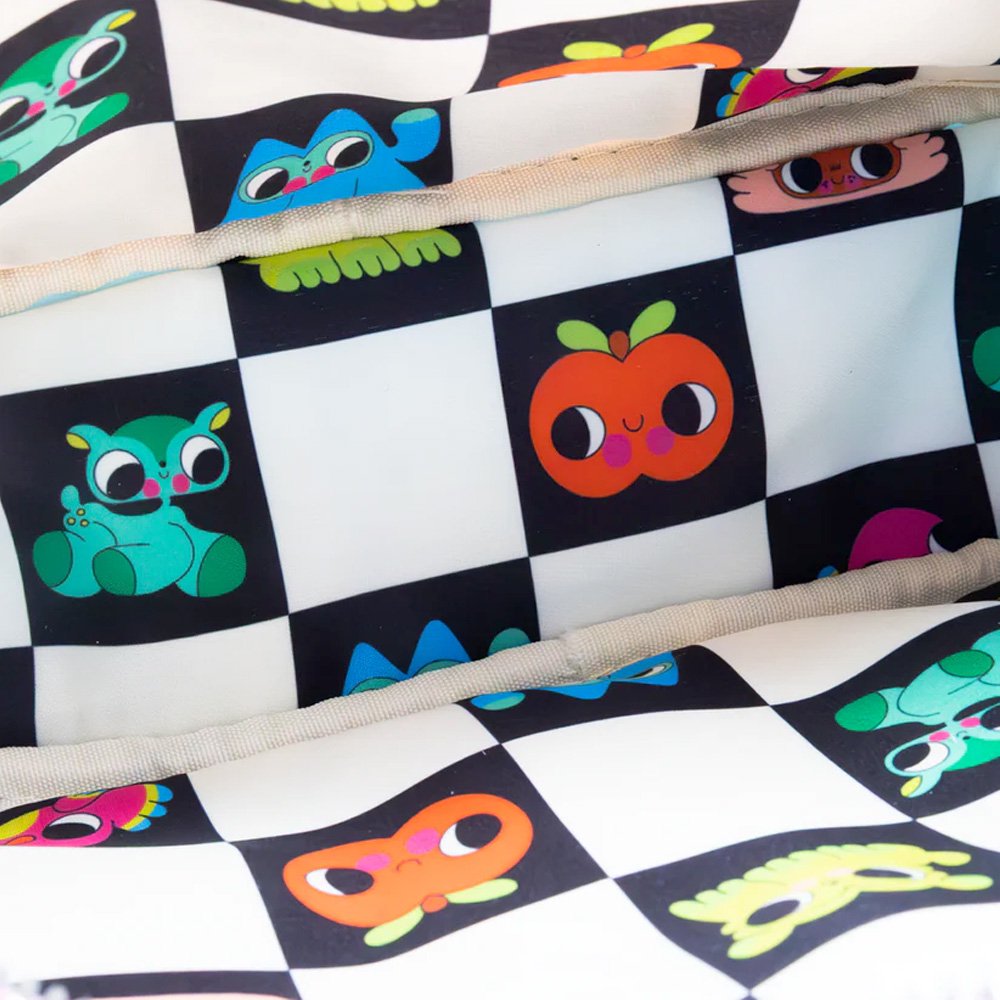 An officially licensed Whatever! blue dome-shaped handbag featuring a large character face with giant black eyes and pink cheeks. The bag is decorated with a green bat-winged patch, a star, and a lightning bolt. It includes blue top handles and a detachable rainbow-striped shoulder strap.