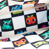 An officially licensed Whatever! blue dome-shaped handbag featuring a large character face with giant black eyes and pink cheeks. The bag is decorated with a green bat-winged patch, a star, and a lightning bolt. It includes blue top handles and a detachable rainbow-striped shoulder strap.