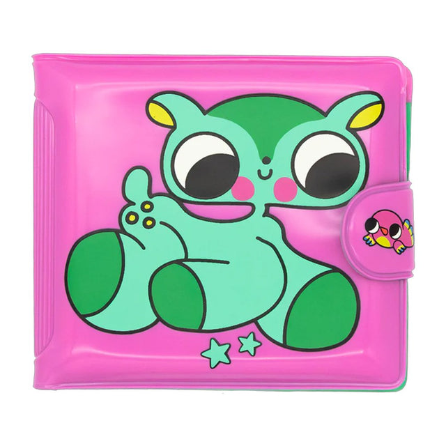 An officially licensed Burger Babie bi-fold wallet in bright pink. The front features a large, stylized green and teal character with big black eyes and pink cheeks. The wallet has a pink snap-closure tab decorated with a small pink bird character, and two small teal stars are printed at the bottom.