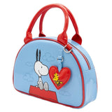 A light blue dome-shaped Snoopy crossbody bowler bag featuring Snoopy sitting on his red doghouse against a cloudy sky, with red handles, a striped rainbow shoulder strap, and a red heart-shaped Woodstock charm.