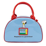 A light blue dome-shaped Snoopy crossbody bowler bag featuring Snoopy sitting on his red doghouse against a cloudy sky, with red handles, a striped rainbow shoulder strap, and a red heart-shaped Woodstock charm.