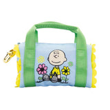 Six miniature duffle-shaped Peanuts character coin pouches in assorted bright pastel colors and floral patterns showcasing characters like Snoopy holding flowers, Woodstock, Lucy, and Charlie Brown
