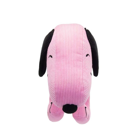 A pink corduroy plush bag shaped like Snoopy with floppy black ears, featuring a small top handle, a detachable pink shoulder strap, and a colorful yellow and blue "PEANUTS" patch on the side