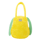 A bright yellow corduroy tote bag shaped like Snoopy's head with long, floppy green ears, subtle embroidered yellow flowers on the face, and a hanging black Peanuts keychain charm
