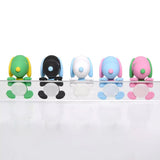 Five colorful miniature Snoopy figures in pastel sherbet colors designed to hang from edges, shown alongside a close-up of a blue and pink Snoopy figure clinging to the corner of a smartphone.
