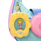 A collection of Polly Pocket mystery items including four colorful character enamel pins and four flower-shaped miniature bag charm keychains in yellow, pink, blue, and mint green.