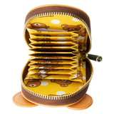 An officially licensed Rilakkuma accordion card wallet. The open view reveals a yellow interior with white polka dots and Rilakkuma patterns, featuring multiple expandable card slots and a gold-tone zipper.