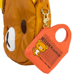 A collection of officially licensed Rilakkuma mystery keychains in a variety of colors. Each keychain is shaped like a small tote bag featuring Rilakkuma and a "have a nice day!" message, and each includes a unique food-themed charm like pancakes or pudding.