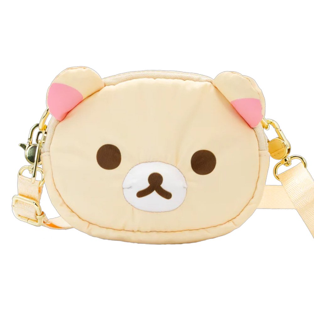 An officially licensed Korilakkuma puffy crossbody bag in an ivory color, shaped like the character's head with round ears. The bag includes a detachable ivory shoulder strap with gold-tone hardware.