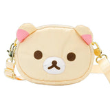 An officially licensed Korilakkuma puffy crossbody bag in an ivory color, shaped like the character's head with round ears. The bag includes a detachable ivory shoulder strap with gold-tone hardware.