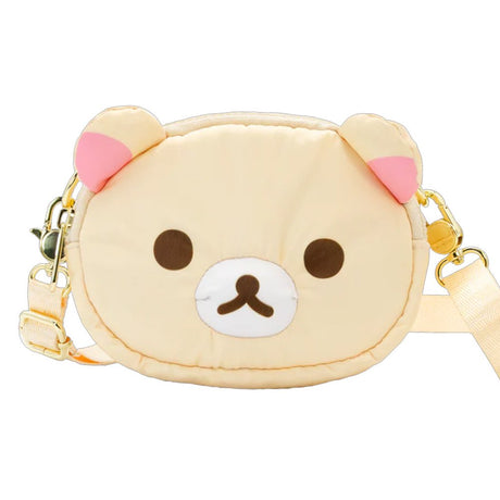 An officially licensed Korilakkuma puffy crossbody bag in an ivory color, shaped like the character's head with round ears. The bag includes a detachable ivory shoulder strap with gold-tone hardware.