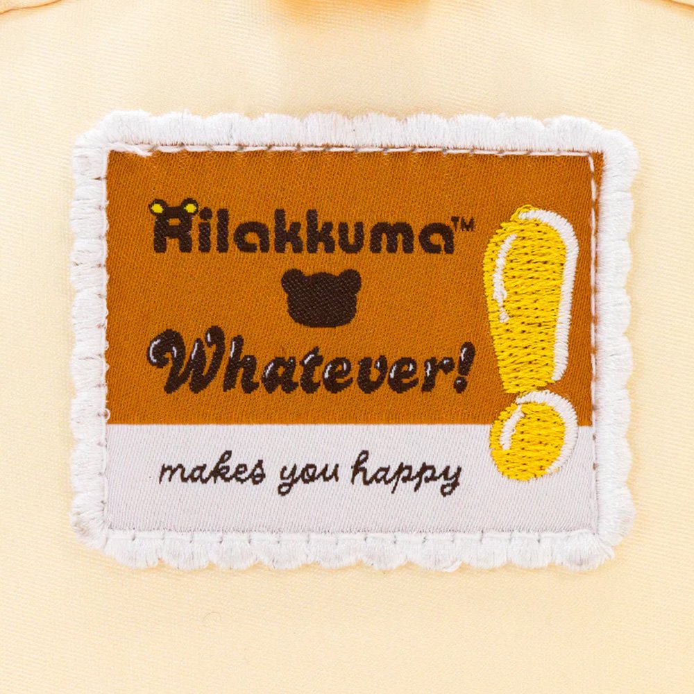 An officially licensed Korilakkuma puffy crossbody bag in an ivory color, shaped like the character's head with round ears. The bag includes a detachable ivory shoulder strap with gold-tone hardware.