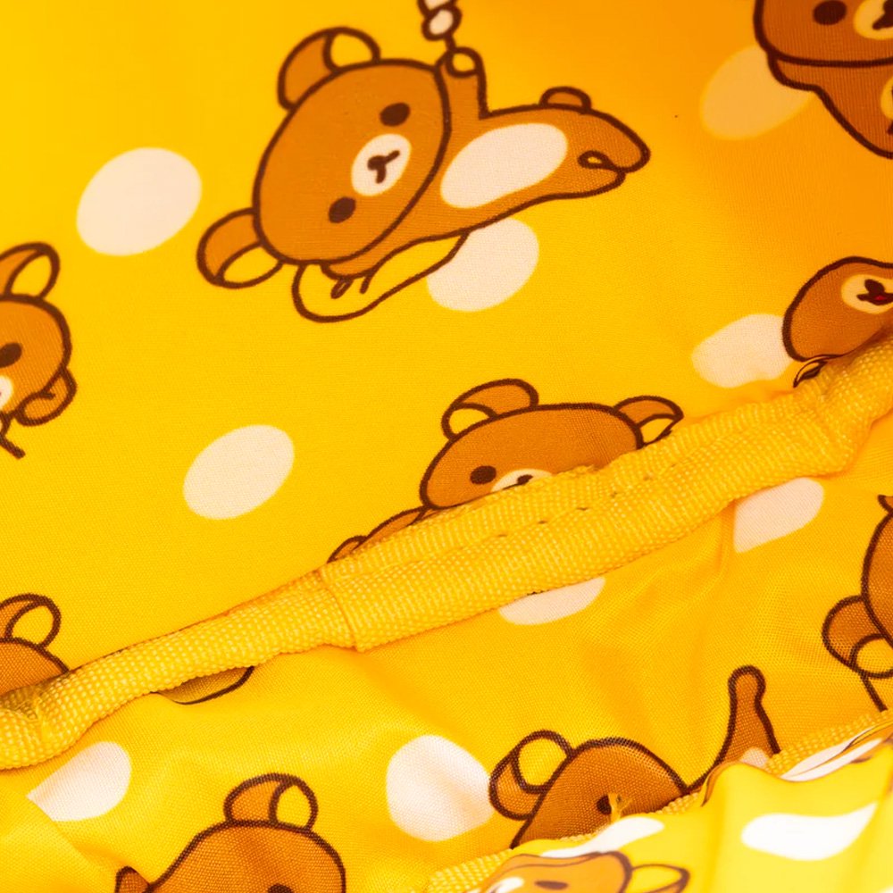 An officially licensed Korilakkuma puffy crossbody bag in an ivory color, shaped like the character's head with round ears. The bag includes a detachable ivory shoulder strap with gold-tone hardware.