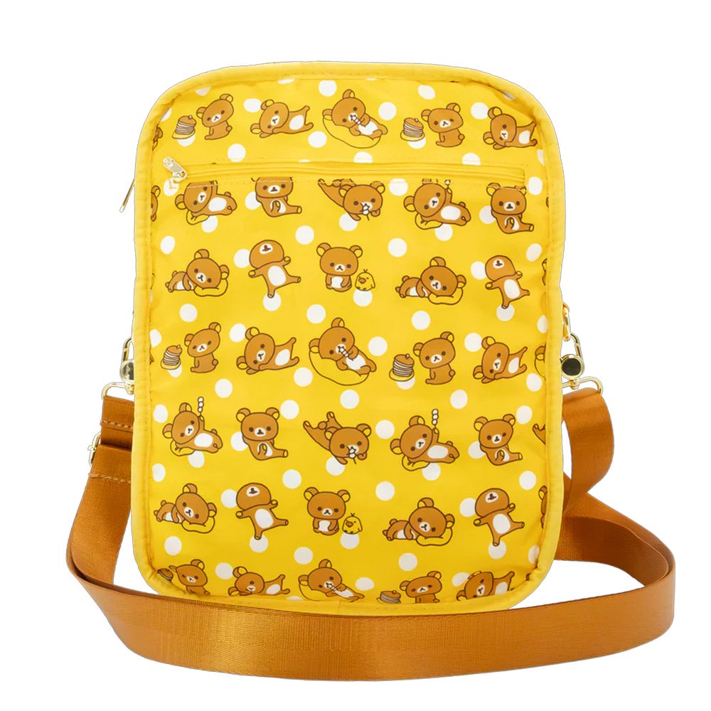 An officially licensed Rilakkuma reversible quilted crossbody bag in yellow color. The front features a repeating pattern of Rilakkuma and a front pocket.