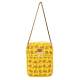 An officially licensed Rilakkuma reversible quilted crossbody bag in yellow color. The front features a repeating pattern of Rilakkuma and a front pocket.