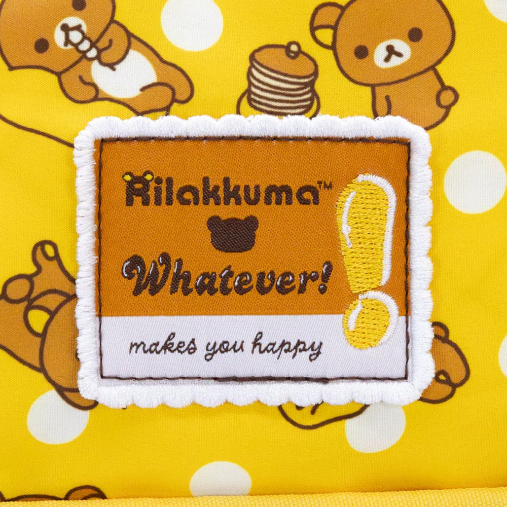An officially licensed Rilakkuma reversible quilted crossbody bag in yellow color. The front features a repeating pattern of Rilakkuma and a front pocket.