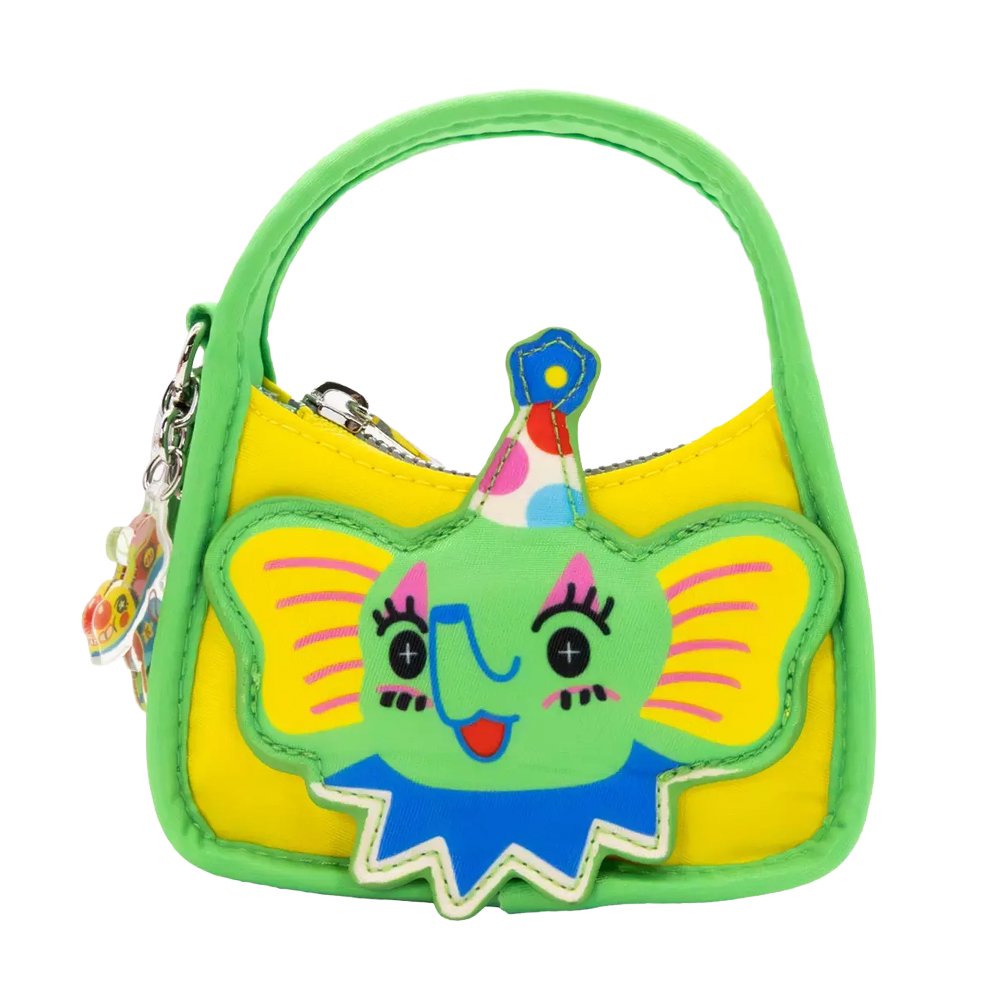 Six miniature, colorful baguette-shaped bag charms featuring whimsical circus animal faces designed by artist So Lazo, arranged around a green and yellow mystery packaging box
